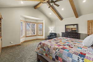 Carpeted bedroom with vaulted ceiling with beams and ceiling fan