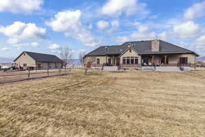 Back of property featuring a yard and a patio