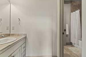 Bathroom with shower / tub combo with curtain and vanity