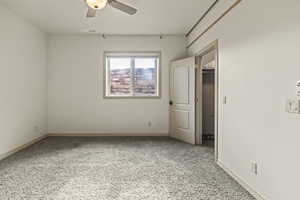 Unfurnished room featuring carpet flooring and ceiling fan