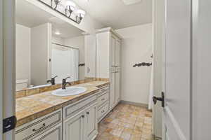 Bathroom with vanity, toilet, and walk in shower