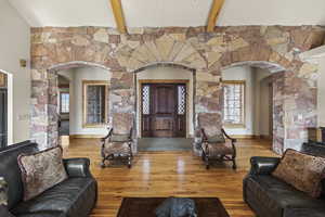 Living room featuring hardwood / wood-style flooring and beamed ceiling