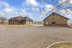 View of home's exterior with a garage and a mountain view