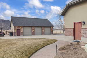 Garage featuring a mountain view and a yard