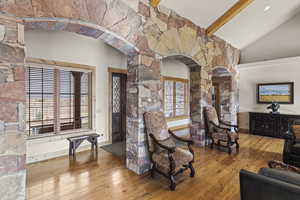 Living room featuring lofted ceiling with beams and hardwood / wood-style floors