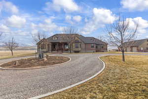 French country style house featuring a mountain view and a front lawn