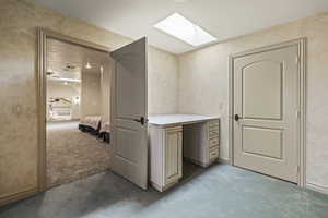 Interior space with light carpet and a skylight