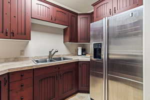 Kitchen with sink and stainless steel fridge