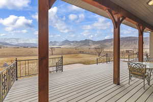 Deck with a rural view and a mountain view