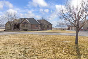 View of front of property with a garage and a front yard