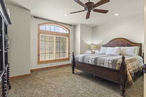 Bedroom with ceiling fan and carpet flooring