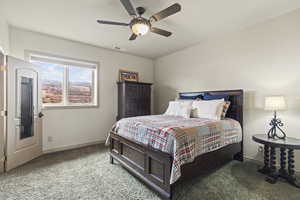 Bedroom with ceiling fan and carpet flooring