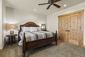 Carpeted bedroom with ceiling fan