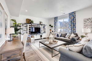 Living room featuring a textured ceiling and light wood-type flooring