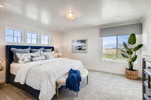 Carpeted bedroom featuring crown molding and a textured ceiling