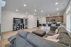 Living room with light hardwood / wood-style floors