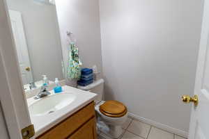 Guest bathroom with vanity, tile floors