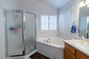 Full bathroom with tile flooring, vanity, independent shower and bath