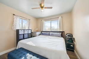 Bedroom featuring dark hardwood / wood-style floors and ceiling fan