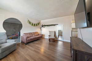 Living room with hardwood / wood-style flooring