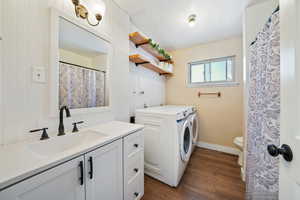 Bathroom/Laundry area featuring dark hardwood / wood-style flooring