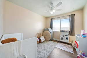 Bedroom with ceiling fan and dark hardwood / wood-style floors