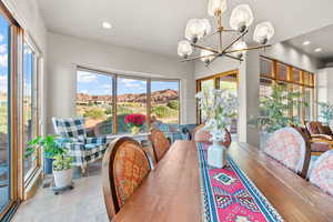 Dining room featuring a mountain view, a wealth of natural light, and a chandelier