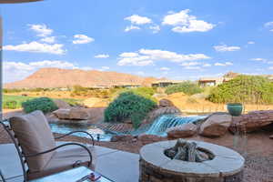 View of patio featuring an outdoor fire pit and a mountain view