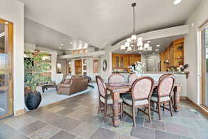 Dining room with lofted ceiling and a chandelier