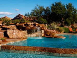 View of pool featuring pool water feature and a mountain view