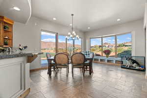 Dining space featuring a mountain view, sink, and a chandelier