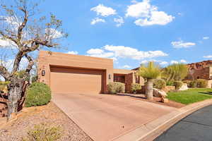 Southwest-style home featuring a garage