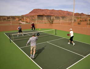 View of sport court featuring a mountain view and basketball hoop