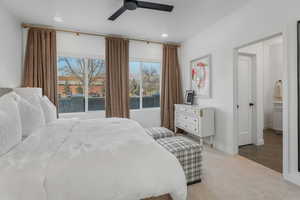 Carpeted bedroom with ceiling fan