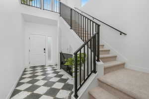 Staircase featuring a towering ceiling