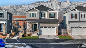 View of front of home with a garage and a mountain view