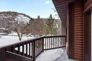 View of snow covered back of property