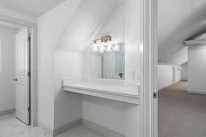 Bathroom with vanity and vaulted ceiling