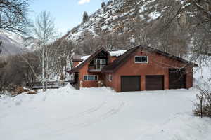 View of front of house with a garage and a mountain view