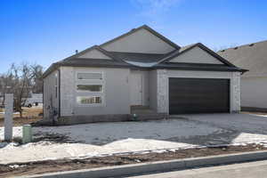 View of front facade featuring a garage