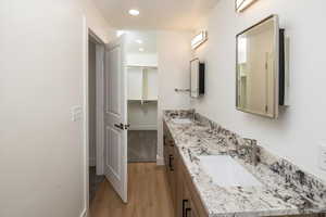 Bathroom featuring vanity and hardwood / wood-style floors