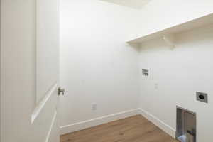 Laundry area featuring hookup for a washing machine, electric dryer hookup, and hardwood / wood-style floors