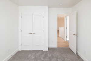 Unfurnished bedroom with carpet floors and a closet