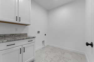 Washroom featuring cabinets, washer hookup, and hookup for an electric dryer