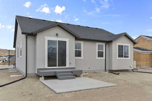 Back of property with a patio area