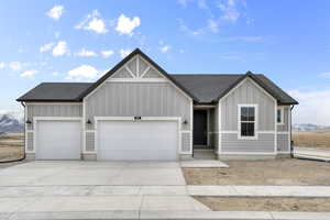 View of front facade featuring a mountain view and a garage