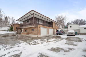 Front of home featuring a balcony and a garage