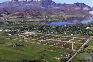 Birds eye view of property featuring a water and mountain view