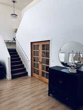 Interior space featuring hardwood / wood-style flooring, french doors, and a chandelier