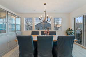 Dining space featuring an inviting chandelier and light hardwood / wood-style flooring